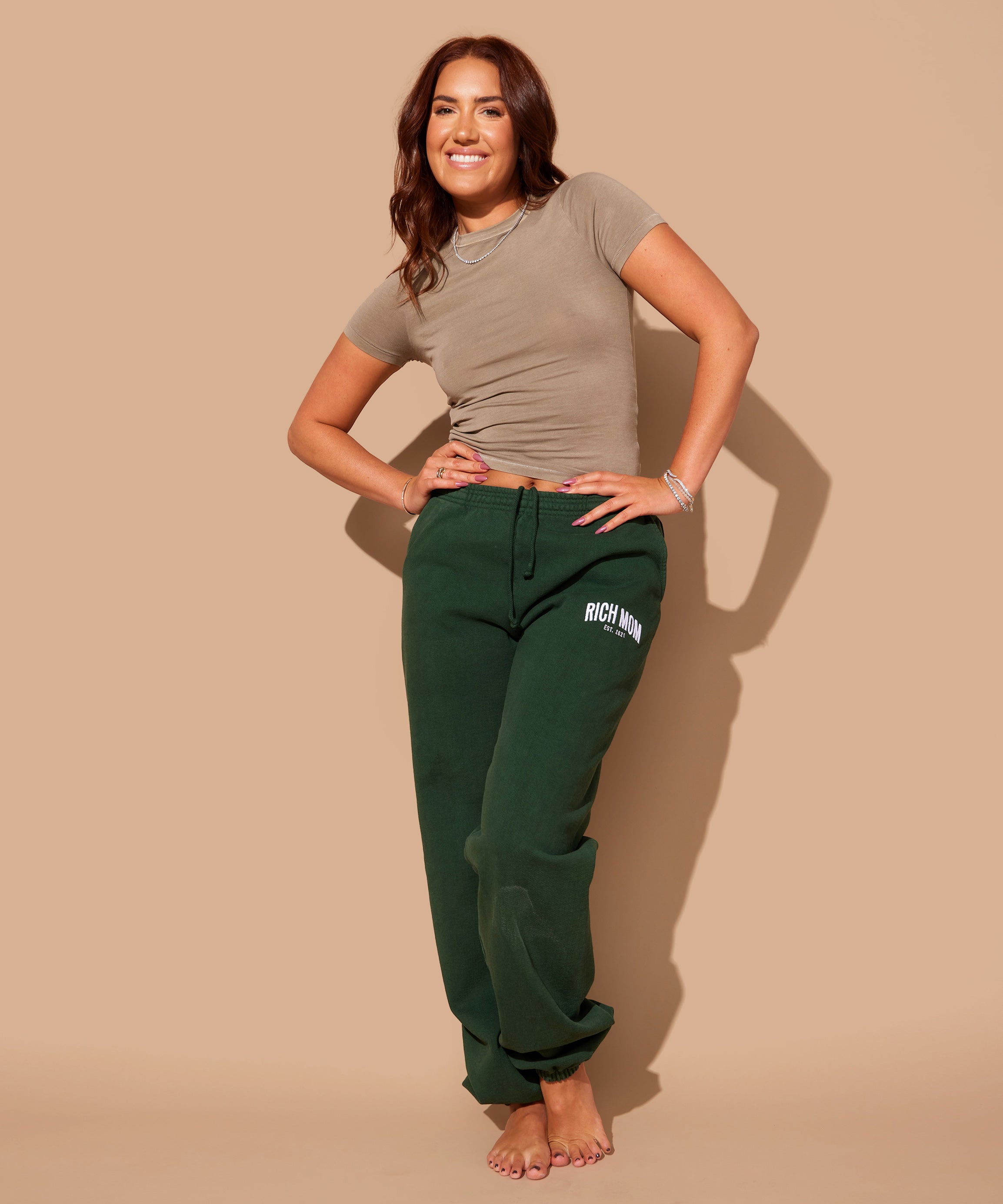 Tinx wears Rich Mom Gear: Essentials Sweatpants in Money Green