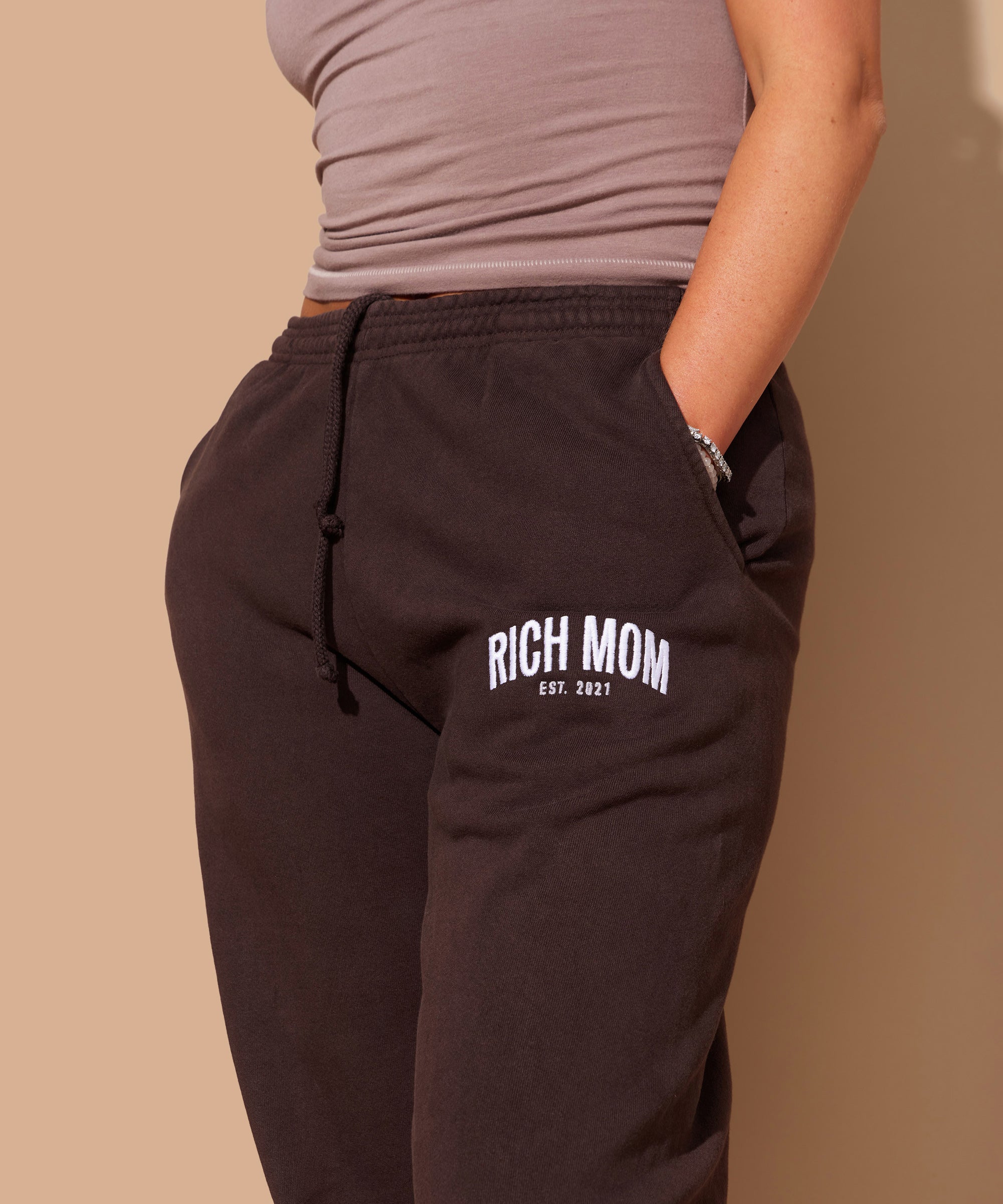 Tinx wears Rich Mom Gear: Essentials Sweatpants in Vegan Keto Chocolate Brownie